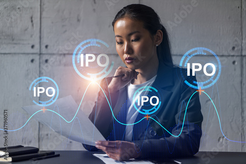 Asian businesswoman dream of success. IPO drawing hologram. Double exposure. photo