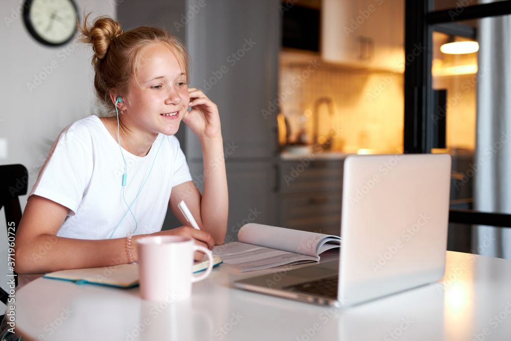 focused school girl preparing project on notebook at home, complete homework using laptop focused school girl preparing project on notebook at home, complete homework using laptop