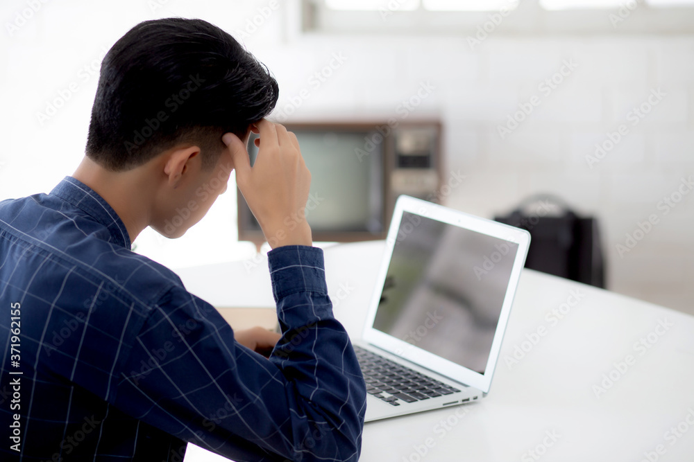 Young asian business man headache during working on laptop computer display blank screen with deadline at home, businessman with failure exhausted, stress and worried, frustrated and unsuccessful. Young asian business man headache during working on laptop computer display blank screen with deadline at home, businessman with failure exhausted, stress and worried, frustrated and unsuccessful.