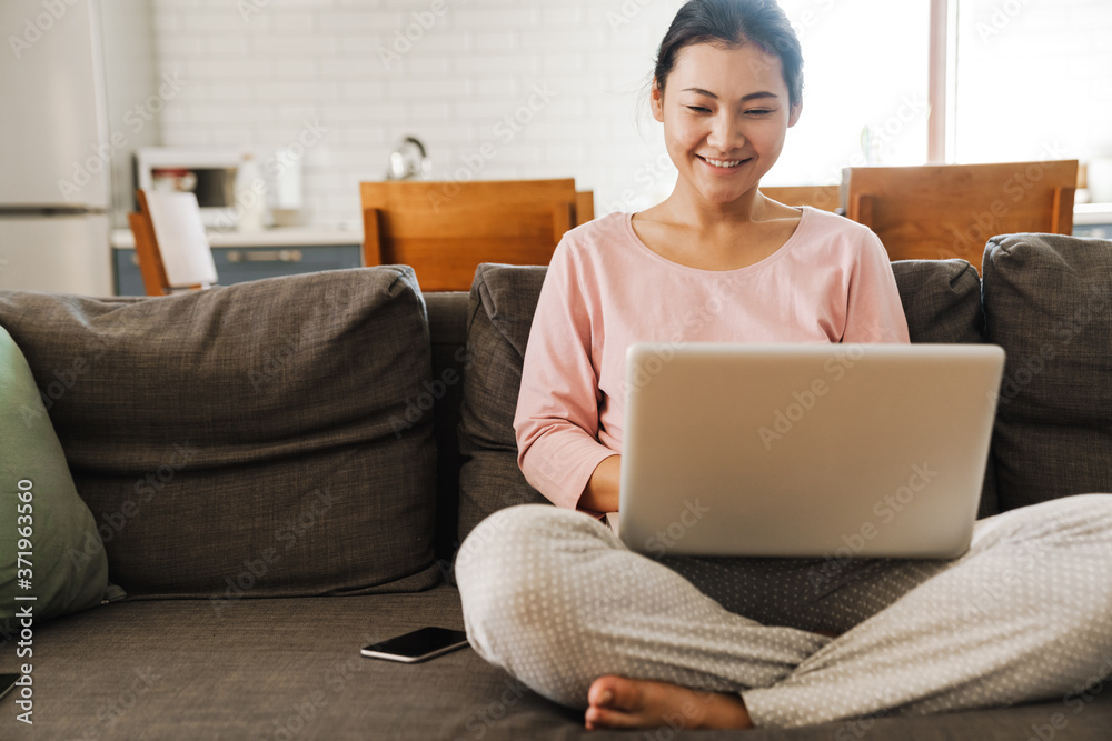 Attractive young asian woman using laptop computer Attractive young asian woman using laptop computer