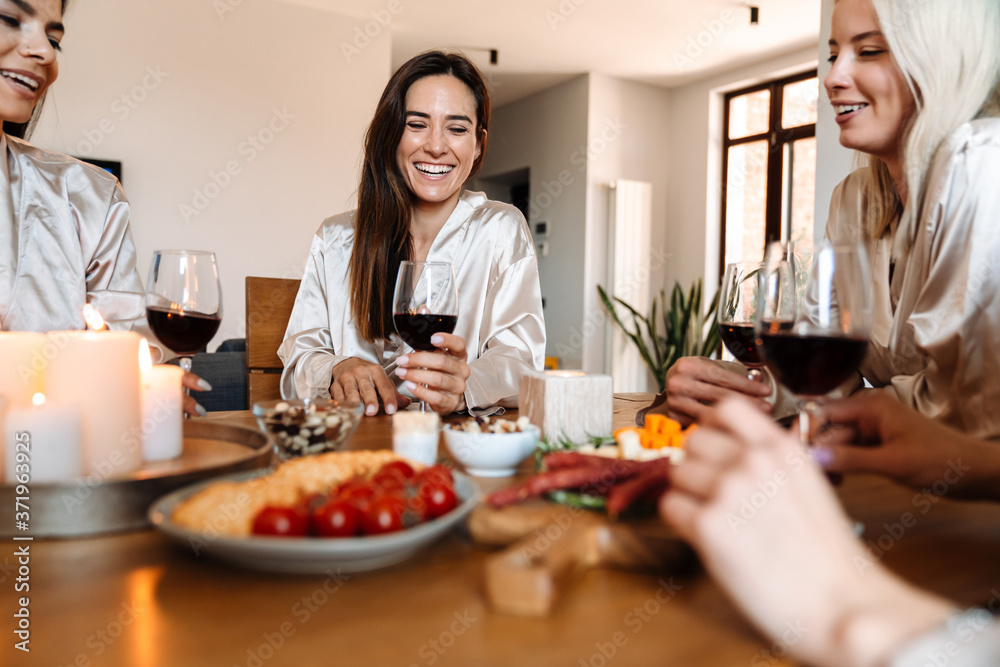 Beautiful cheerful girlfriends in kitchen