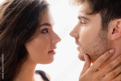 side view of woman and man looking at each other isolated on white