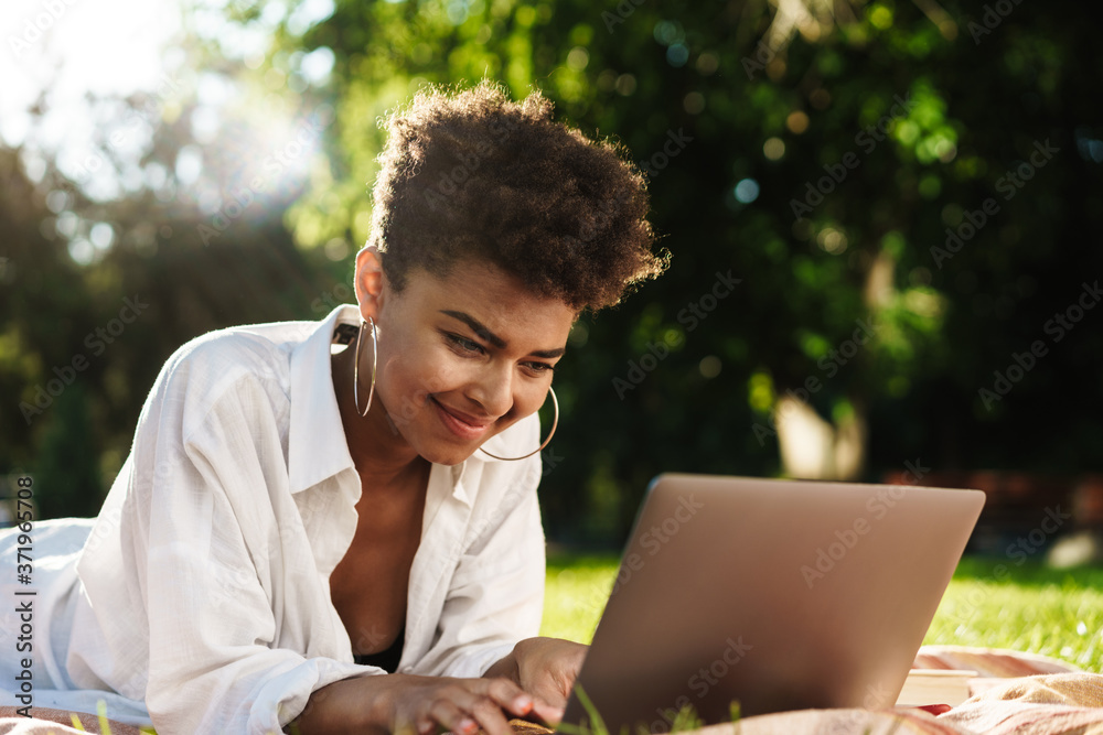 Beautiful young african woman using laptop Beautiful young african woman using laptop