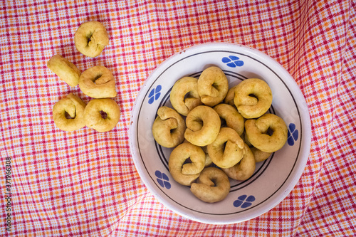 Homemade taralli crackers in a traditional Apulian ceramic bowl photo