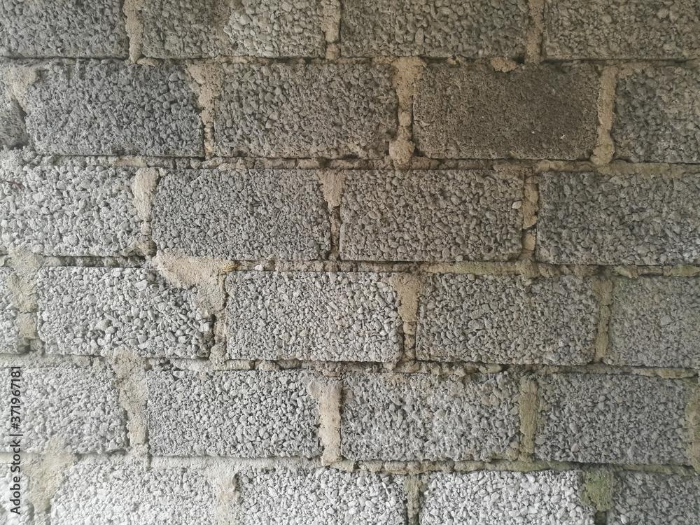 A Wall made of cement blocks and concrete like texture. A Wall made of cement blocks and concrete like texture.