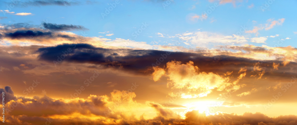 golden sunset sky landscape background natural color of evening cloudscape panorama with setting sun and clouds ultra wide panoramic view golden sunset sky landscape background natural color of evening cloudscape panorama with setting sun and clouds ultra wide panoramic view