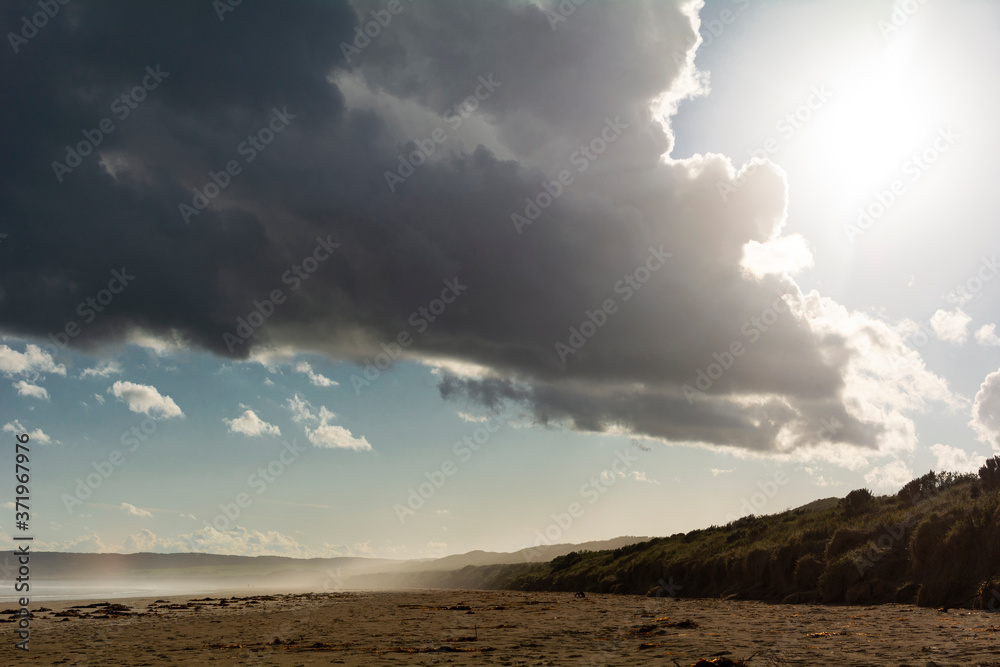Beach with sun and storm