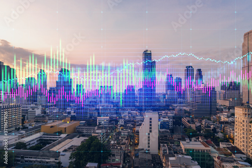 Sunset cityscape of Bangkok city view background with forex graph. Success and finance concept. Multiexposure