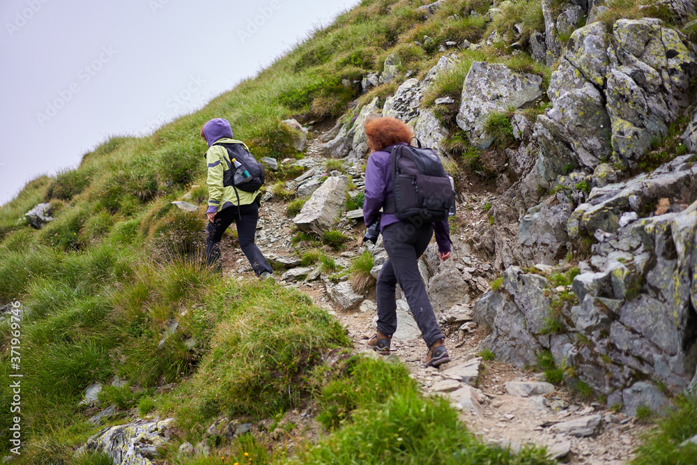 Friends hiking in the mountains Friends hiking in the mountains