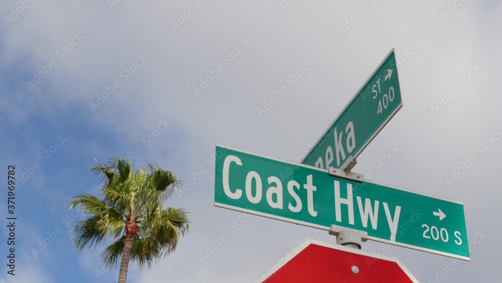Fototapeta premium Pacific Coast Highway, historic route 101 road sign, tourist destination in California USA. Lettering on intersection signpost. Symbol of summertime travel along the ocean. All-American scenic hwy