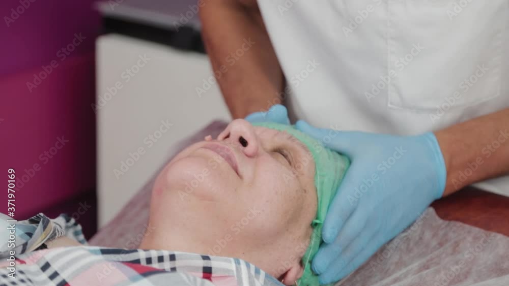 Male doctor putting a hat on a woman. Male doctor putting a hat on a woman.
