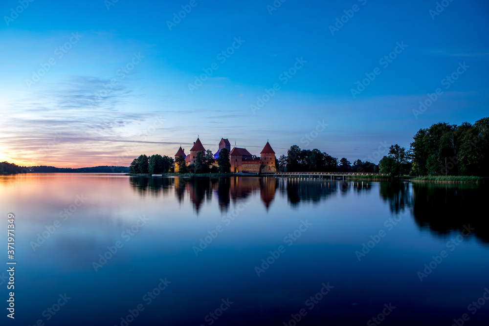Fototapeta premium Trakai Castle after sunset in the lake Galve, Lithuania