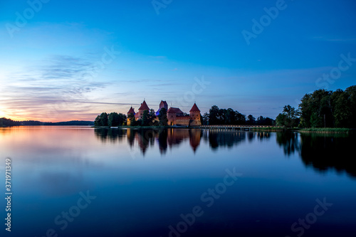 Trakai Castle after sunset in the lake Galve, Lithuania