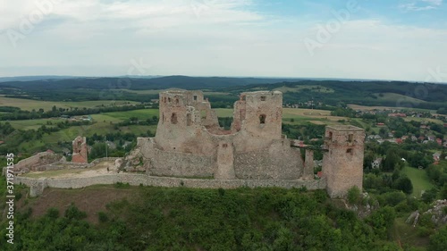 Csesznek, Hungary - 4K drone flying above the ruins of the Castle of Csesznek lies in the Bakony in the village of Csesznek on a summer afternoon photo