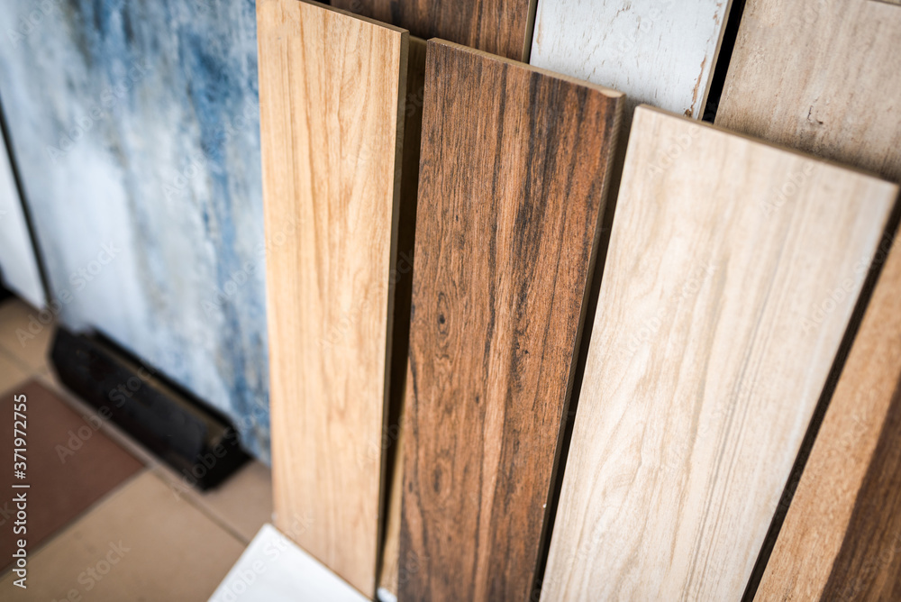 Variety of wooden like tiles. Samples of fake wood tiles for flooring.  Assortment of floor laminate / tiles in an interior shop. Stock Photo
