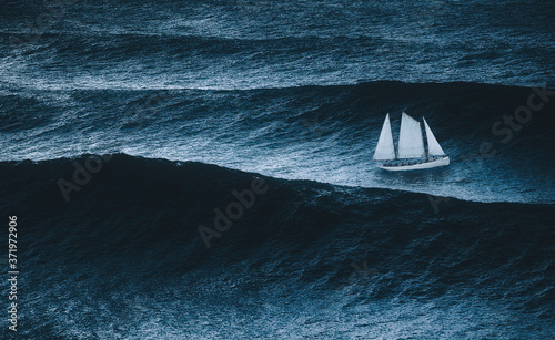 Fotografiet sailboat on the sea with storm and big waves