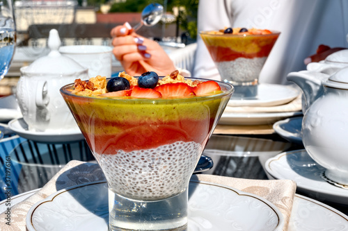 Chia pouding with fruits on a glass on a restaurant table photo