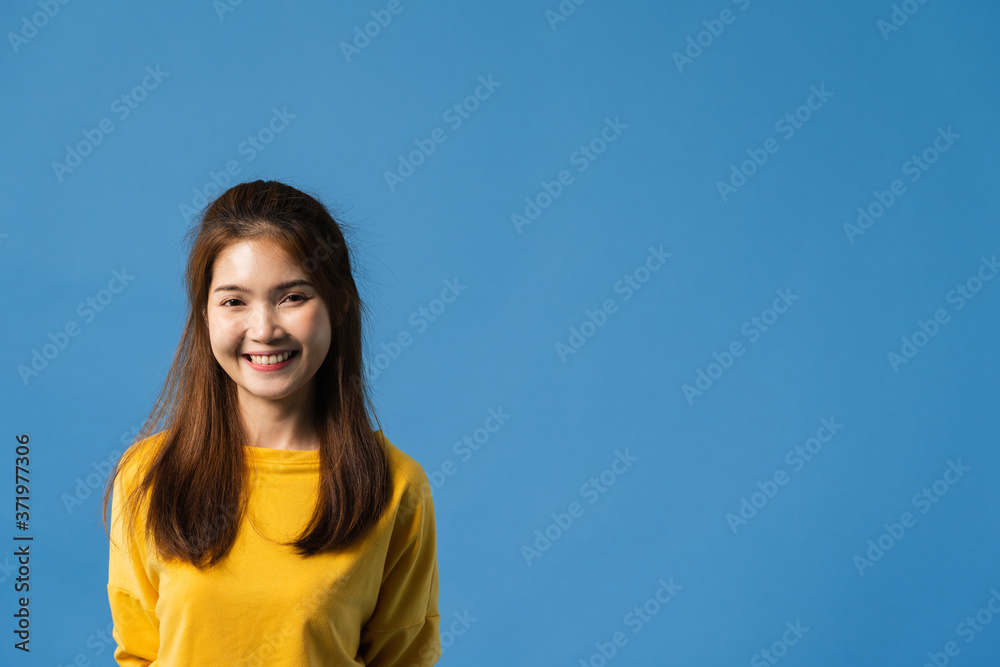 Young Asia lady with positive expression, smile broadly, dressed in casual clothing and looking at camera over blue background. Happy adorable glad woman rejoices success. Facial expression concept. Young Asia lady with positive expression, smile broadly, dressed in casual clothing and looking at camera over blue background. Happy adorable glad woman rejoices success. Facial expression concept.