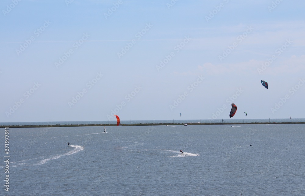 kitesurfers sailing on the water
