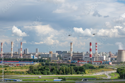 Helicopters fly over an industrial area on the outskirts of Moscow