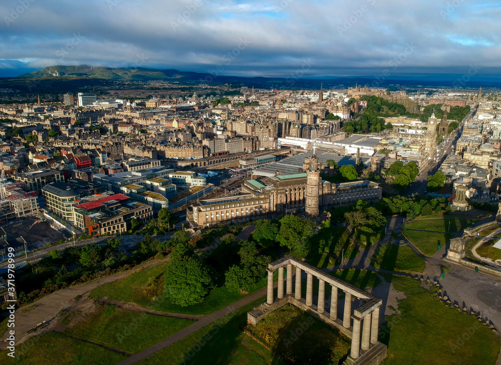 Aerial summer view of Edinburgh Scotland, with Calton Hill and its famous landmarks such as the Nelson Monument, National Monument of Scotland and Dugald Stewart Monument