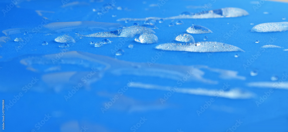 
Water drops on blue waterproof fabric background