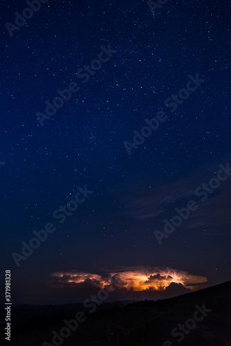 Stars and thunderbolts on night sky in Brecon Beacons National Park in Wales.