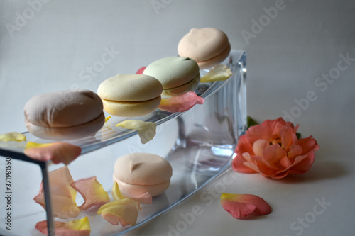 delicate marshmallow on a glass stand with rose petals