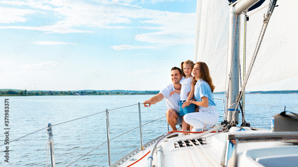 Parents And Daughter Sitting On Yacht Deck Sailing Outside, Panorama Parents And Daughter Sitting On Yacht Deck Sailing Outside, Panorama