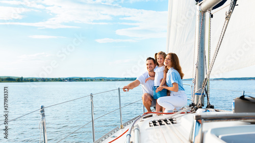 Parents And Daughter Sitting On Yacht Deck Sailing Outside, Panorama