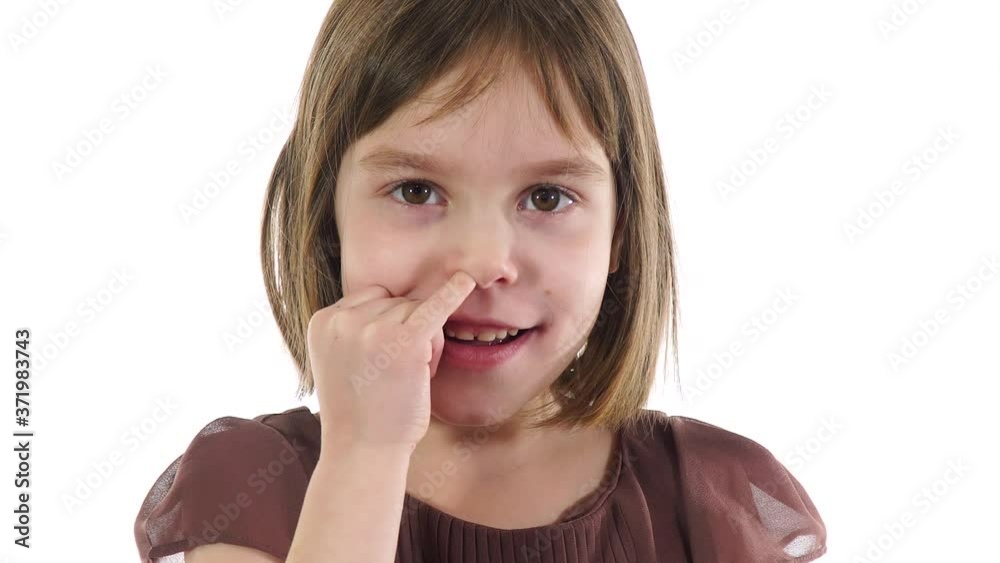 Blonde caucasian girl 6-7 years, nose picking using index finger. Blonde caucasian girl 6-7 years, nose picking using index finger.