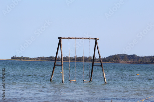 Bilene, Gaza, Mozambique - July, 2020 - the coast of Mozambique, a playground into the lagoon, next to the sea. Blue sky and clean water  photo