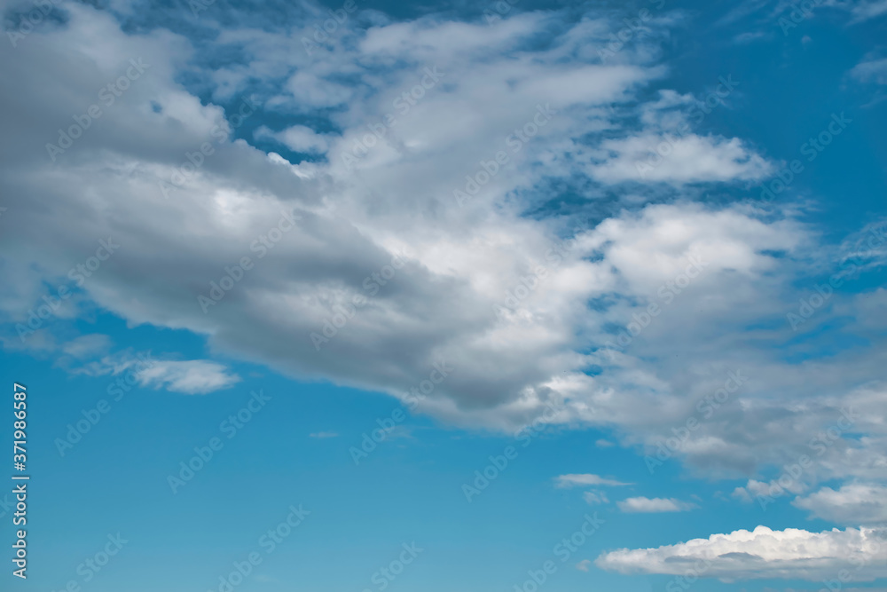 Beautiful blue sky with with light puffy cirrus clouds background