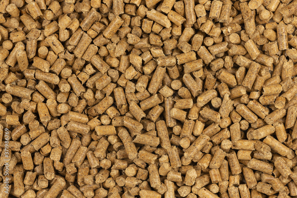Brown wood pellets texture background. natural pile of wood pellets. organic biofuels. Alternative biofuel from sawdust. The cat litter. pile of compressed wood pellets. Brown wood pellets texture background. natural pile of wood pellets. organic biofuels. Alternative biofuel from sawdust. The cat litter. pile of compressed wood pellets.
