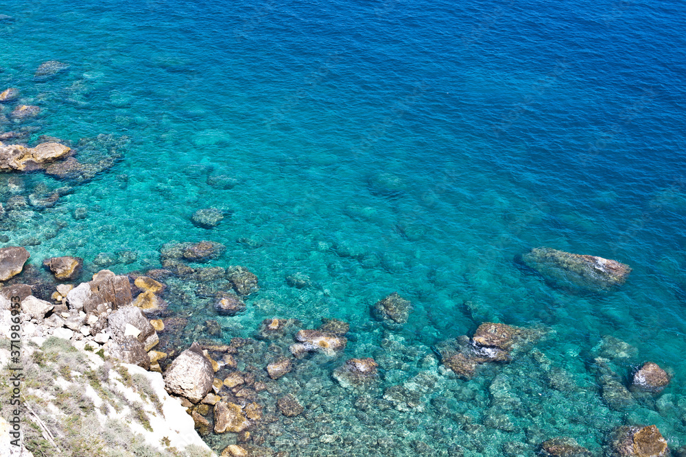 Aerial view of rocks on the sea. Overview of the seabed seen from above, transparent water