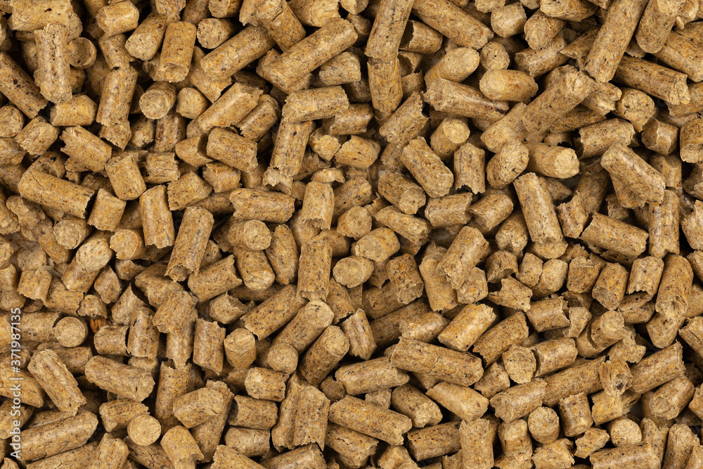 Brown wood pellets texture background. natural pile of wood pellets. organic biofuels. Alternative biofuel from sawdust. The cat litter. pile of compressed wood pellets. Brown wood pellets texture background. natural pile of wood pellets. organic biofuels. Alternative biofuel from sawdust. The cat litter. pile of compressed wood pellets.