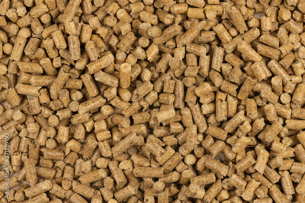 Brown wood pellets texture background. natural pile of wood pellets. organic biofuels. Alternative biofuel from sawdust. The cat litter. pile of compressed wood pellets. Brown wood pellets texture background. natural pile of wood pellets. organic biofuels. Alternative biofuel from sawdust. The cat litter. pile of compressed wood pellets.