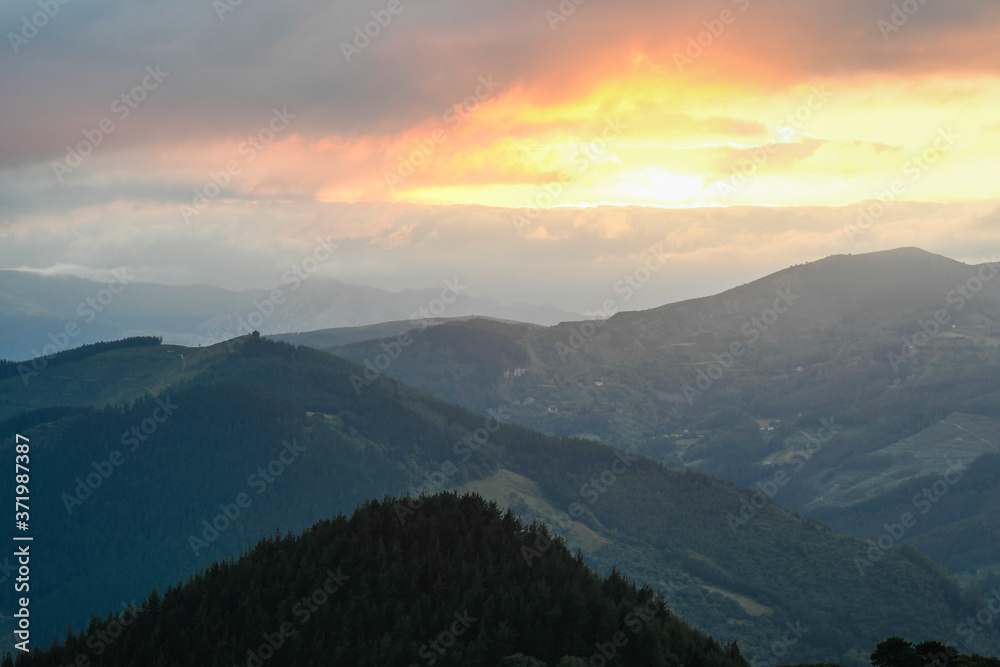 Fototapeta premium Sunset from Mount Ubieta, with the sun through the clouds
