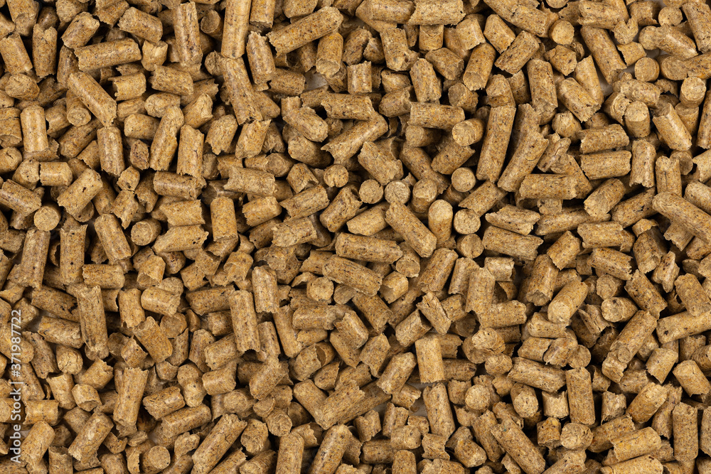 Brown wood pellets texture background. natural pile of wood pellets. organic biofuels. Alternative biofuel from sawdust. The cat litter. pile of compressed wood pellets. Brown wood pellets texture background. natural pile of wood pellets. organic biofuels. Alternative biofuel from sawdust. The cat litter. pile of compressed wood pellets.