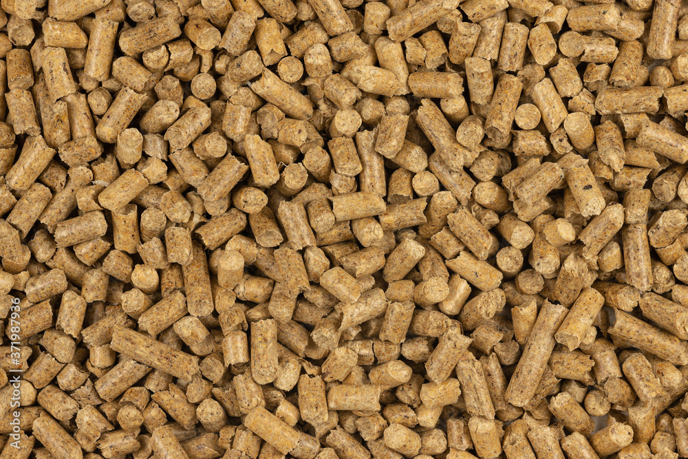 Brown wood pellets texture background. natural pile of wood pellets. organic biofuels. Alternative biofuel from sawdust. The cat litter. pile of compressed wood pellets. Brown wood pellets texture background. natural pile of wood pellets. organic biofuels. Alternative biofuel from sawdust. The cat litter. pile of compressed wood pellets.