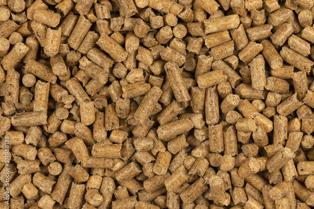 Brown wood pellets texture background. natural pile of wood pellets. organic biofuels. Alternative biofuel from sawdust. The cat litter. pile of compressed wood pellets. Brown wood pellets texture background. natural pile of wood pellets. organic biofuels. Alternative biofuel from sawdust. The cat litter. pile of compressed wood pellets.