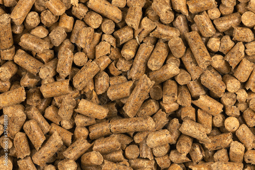 Brown wood pellets texture background. natural pile of wood pellets. organic biofuels. Alternative biofuel from sawdust. The cat litter. pile of compressed wood pellets.