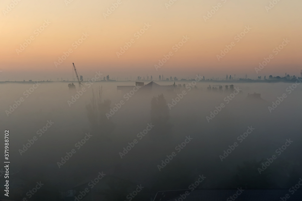 Fototapeta premium Vague silhouettes of Koblevo skyline in the morning mist, Ukraine