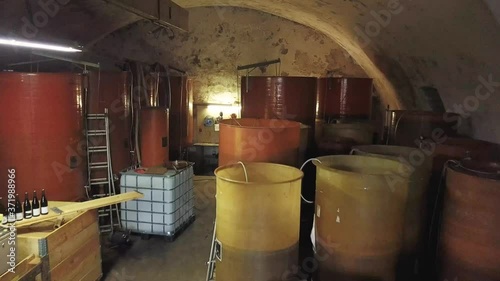Flying backwards within a cellar over multiple vats, wine production