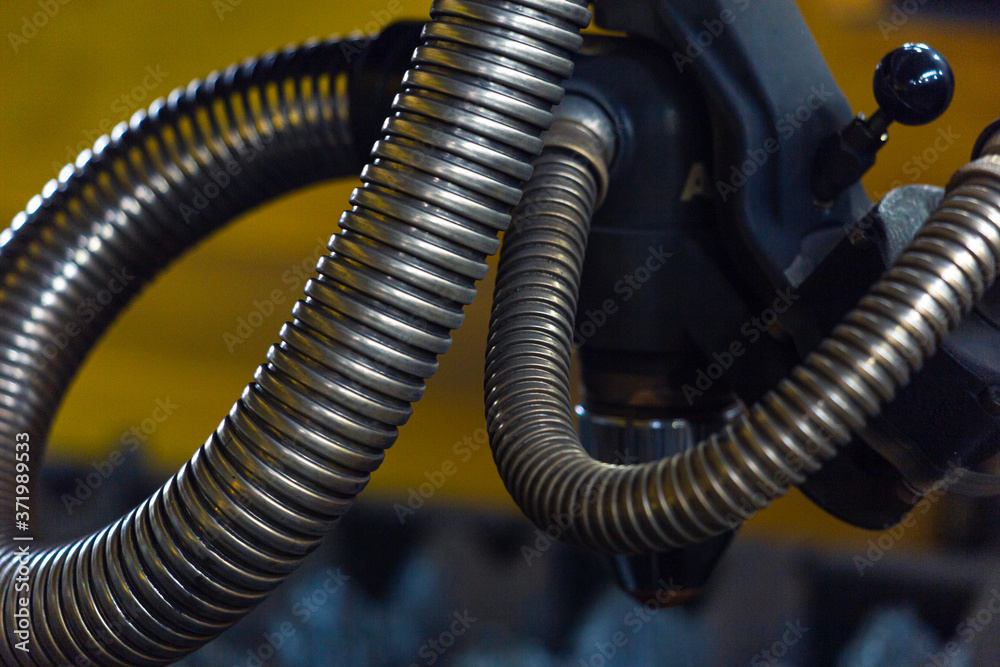Metal protection of pipelines and wires on a machine in a repair shop. Metal protection of pipelines and wires on a machine in a repair shop.