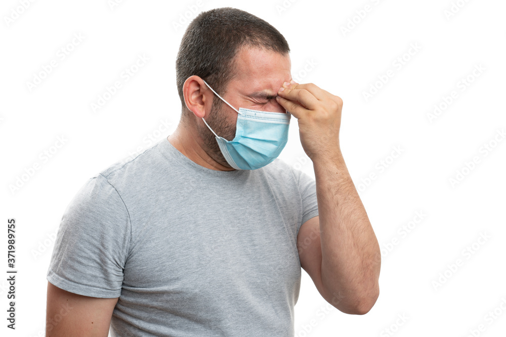 Man wearing mask headache touching forehead as focused concept Man wearing mask headache touching forehead as focused concept