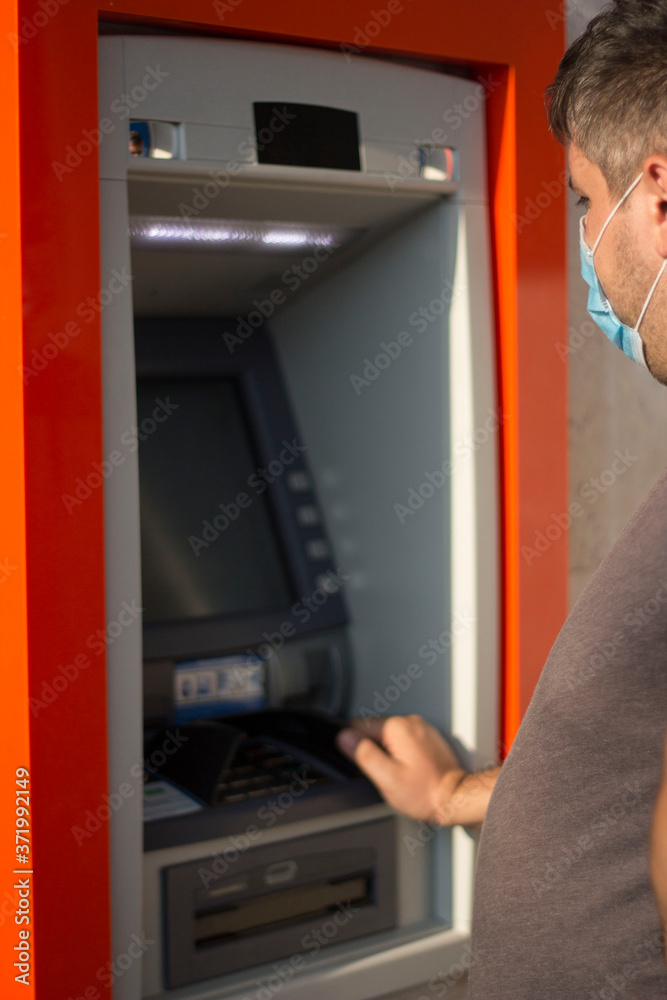 man using credit card in atm man using credit card in atm
