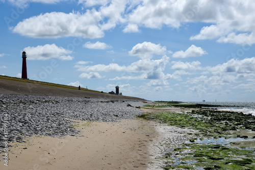 Lighthouse 'Lange Jaap' and the coastguard tower near Huisduinen, Den Helder. photo