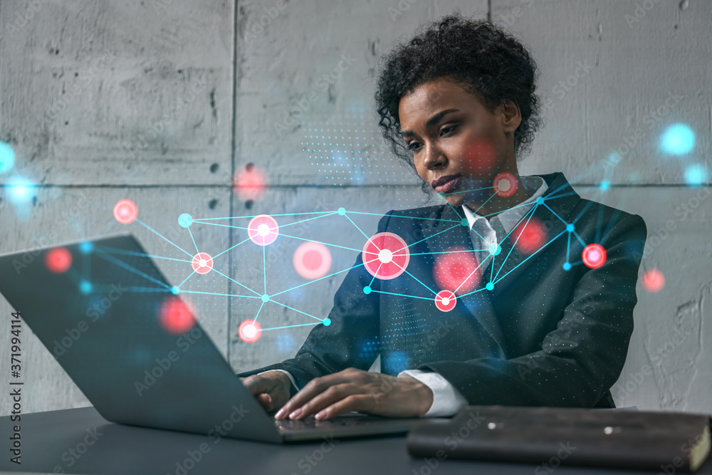 Businesswoman typing on laptop work in modern office on new project. Abstract tech icon drawing hologram. Double exposure. Concept of success. Businesswoman typing on laptop work in modern office on new project. Abstract tech icon drawing hologram. Double exposure. Concept of success.