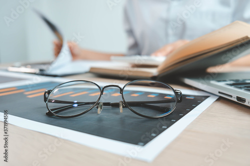 Eyeglasses for people with visual impairments or people who work always staring at the computer, placed on the desk in the office